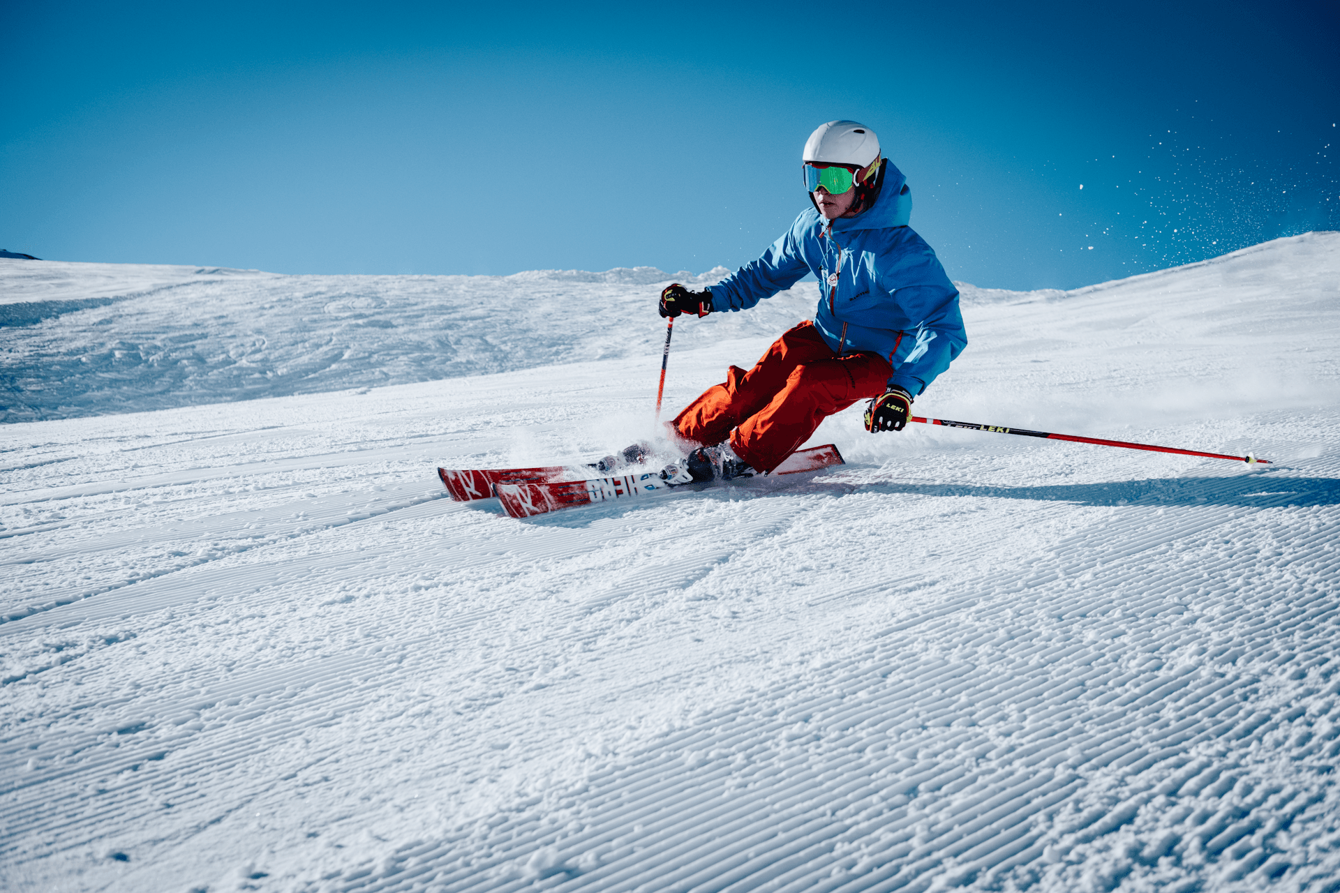 Skier carving on groomed snow